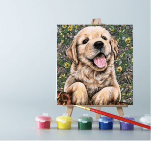 An easel with paints and Adorable Puppy paint by number canvas on it