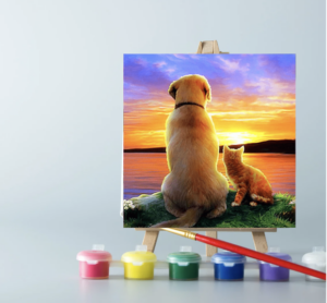 An easel with paints and a Dog and Cat Sunset paint by number canvas on