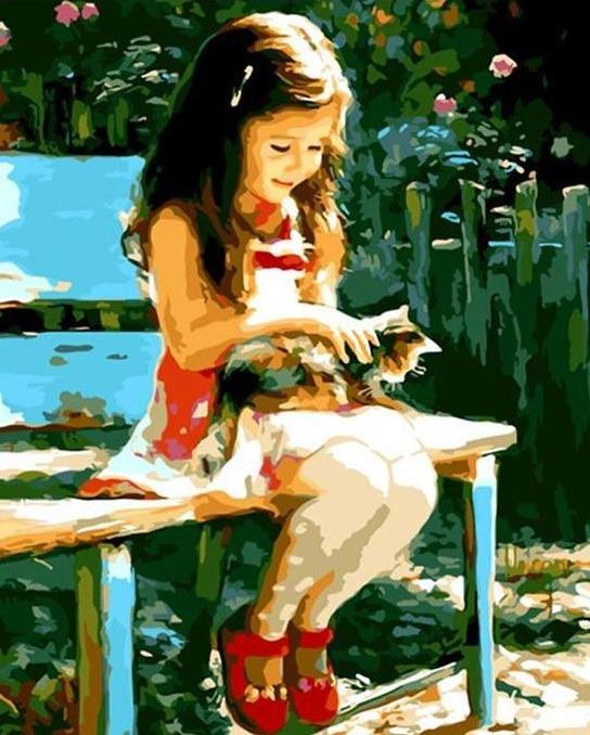 girl sitting on a bench with a kitten