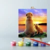 An easel with paints and a Dog and Cat Sunset paint by number canvas on