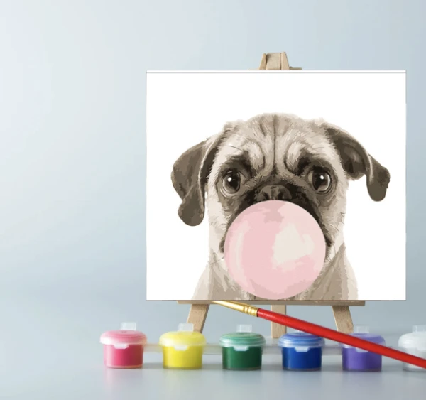 An easel with paints and a paint by number on canvas on it