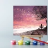 An easel with a Pink Sunset paint by number canvas on it