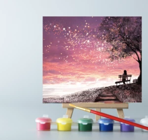 An easel with a Pink Sunset paint by number canvas on it 