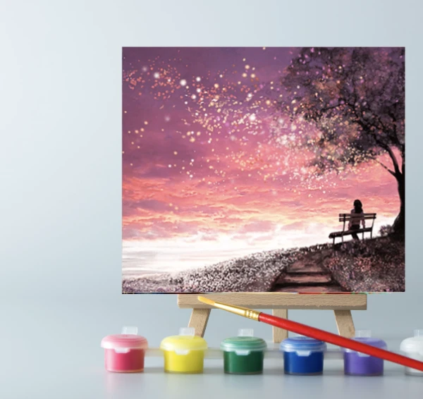 An easel with a Pink Sunset paint by number canvas on it